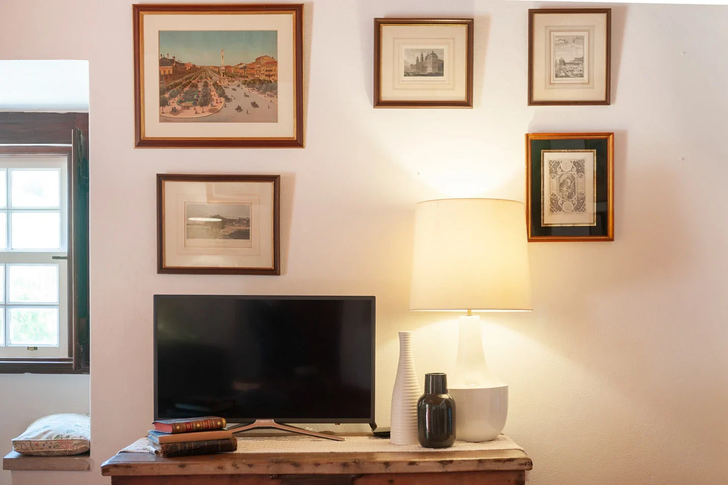 Detail of a wall with several frames in the living room of Pinetree house